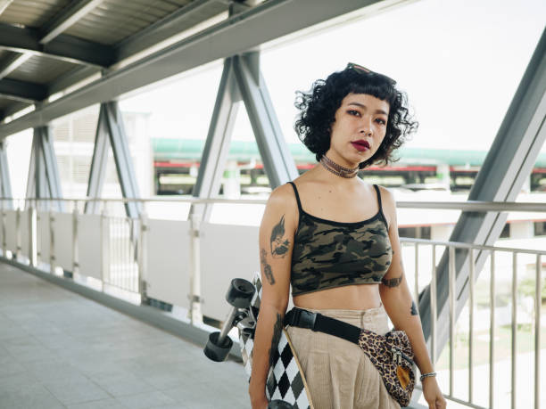 istock Hipster asian women going to play skateboarding. 1300509509