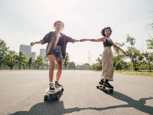 Asian girls skateboarder practicing in the public park. Asian girls skateboarder practicing in the public park on weekend. extreme skateboarding stock pictures, royalty-free photos & images