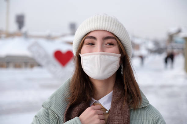 istock Asian women in protectve mask smiling 1300510323