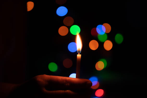 istock The hand that protects the candles in the dark. 1300510854