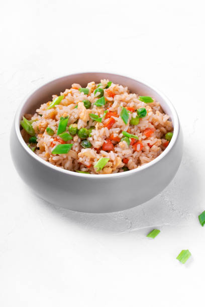 istock Fried rice with vegetables and egg in the gray ceramic bowl 1300512073