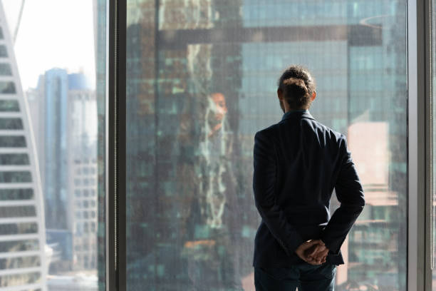 istock Back view of businessman look in distance thinking 1300512216