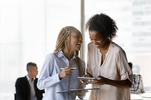 istock Happy multiracial female colleagues laugh brainstorming in office 1300512248