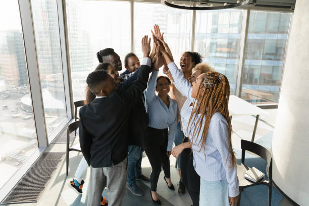 istock Overjoyed multiracial employees give high five at meeting 1300512266