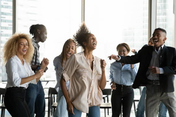 istock Overjoyed multiracial colleagues dance have fun in office 1300512270