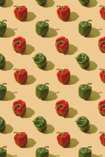 istock Red and green bell peppers on a pastel beige background. Creative fresh vegetables pattern. 1300513074