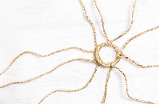 The concept is made of rope on a white wooden background
