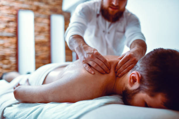 istock Relaxing Massage By Expert Masseur For Male Patient 1300514171