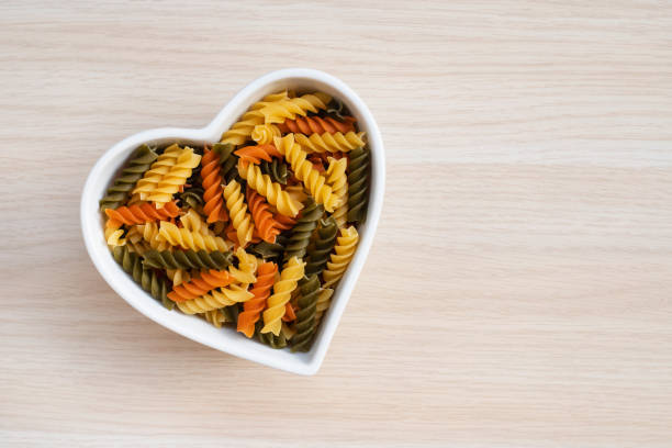 istock diet pasta in a heart shaped bowl. 1300514883
