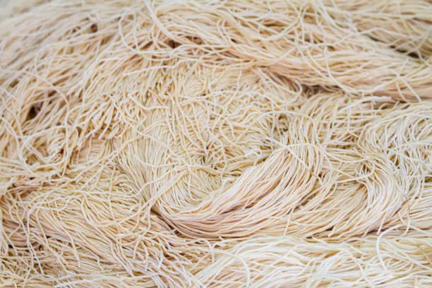Photo of Yellow noodles or Mee Sua food drying in the sunlight Making sun dried in Thailand are Chinese noodle vegetable in vegetarian festival.