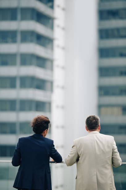 istock Business colleagues looking at cityscape 1300515538