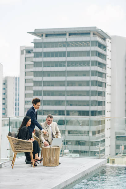 istock Businessman showing report to colleagues 1300515542