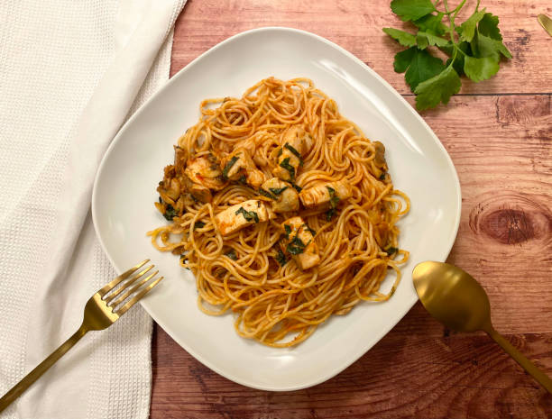 istock Chicken strips with mushroom and spaghetti pasta in tomato sauce. 1300516327