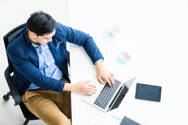 successful of asian young businessman working with hand typing keyboard on laptop computer, tablet with blank touch screen isolated and pen on notebook on white wooden table background in office - typewriter key audio imagens e fotografias de stock