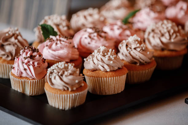 istock Cupcakes with curls of creamy strawberry glaze 1300516566