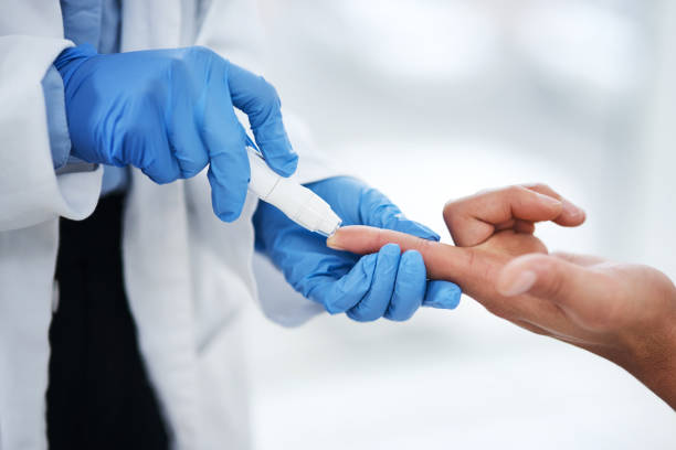 Know your levels, it might save your life Shot of an unrecognisable doctor using a blood sugar test on his patient’s finger diabetes stock pictures, royalty-free photos & images