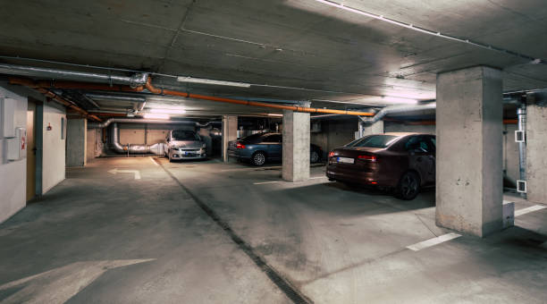 istock Cars on underground parking in modern residential complex. 1300517762