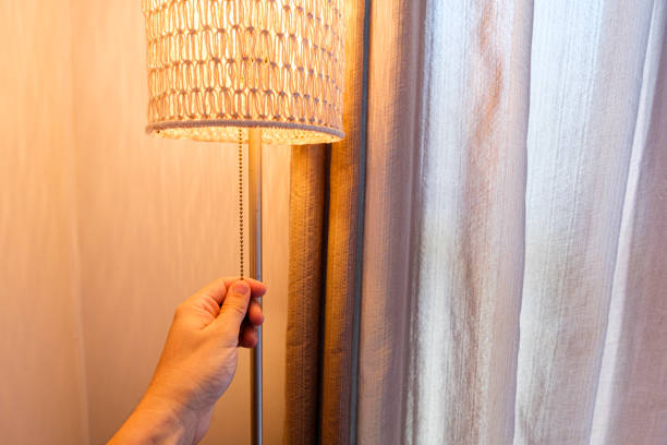 istock Registration of man turning on lamp light. Electricity usage concept 1300518116
