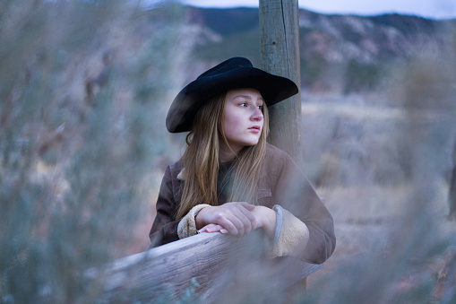 Cowgirl Environmental Portrait Outdoors - Girl with cowboy hat outdoors.