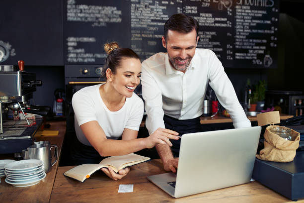 istock Coffee shop small business owners working with laptop 1300520698