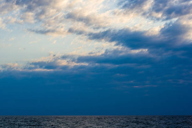 istock Amazing sea sunset on the pebble beach, the sun, waves, clouds 1300521409