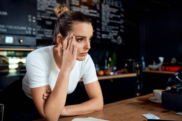 Frustrated small business owner in closed cafe Frustrated small business owner in closed cafe lockdown business stock pictures, royalty-free photos & images