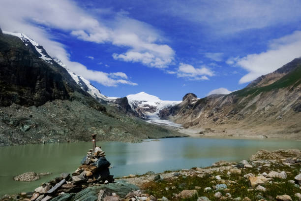istock stacked stones on a lake with a mountain and a glacier 1300521709
