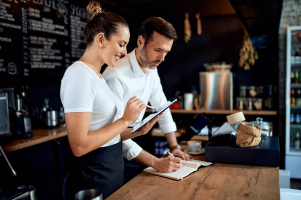 istock Small business owner doing bookkeeping at restaurant cafe. 1300521753