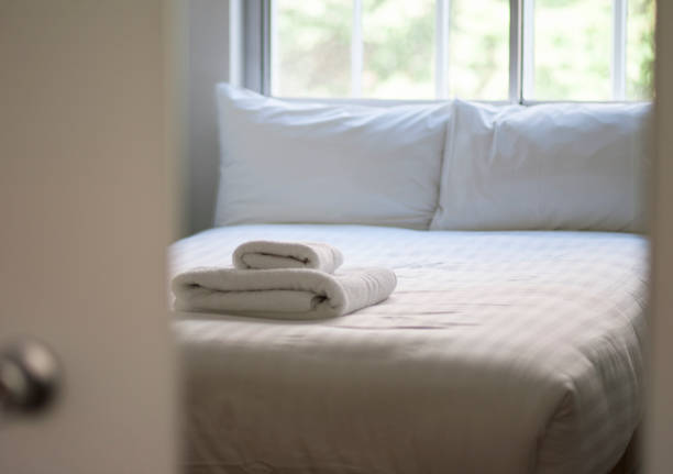 Comfortable hotel bedroom Comfortable hotel bedroom in cozy style with white linen, towels and pillows. country inn stock pictures, royalty-free photos & images