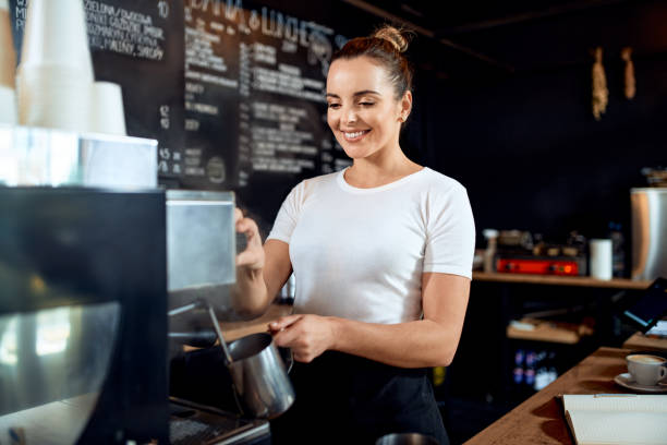 istock Smiling female barista preparing coffee at cafe 1300522166