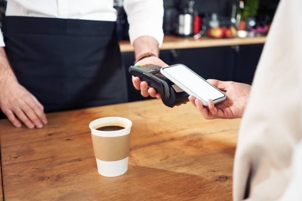 istock Paying with mobile phone at cafe. Contactless payment concept 1300522281