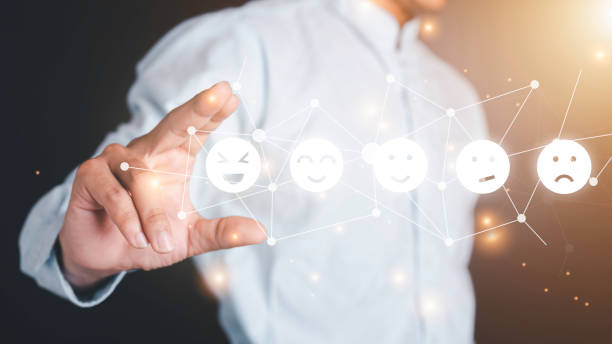 istock Businessman pressing feeling icon on face from a virtual screen. Ideas about satisfaction and opinions. Technology effects. 1300523147