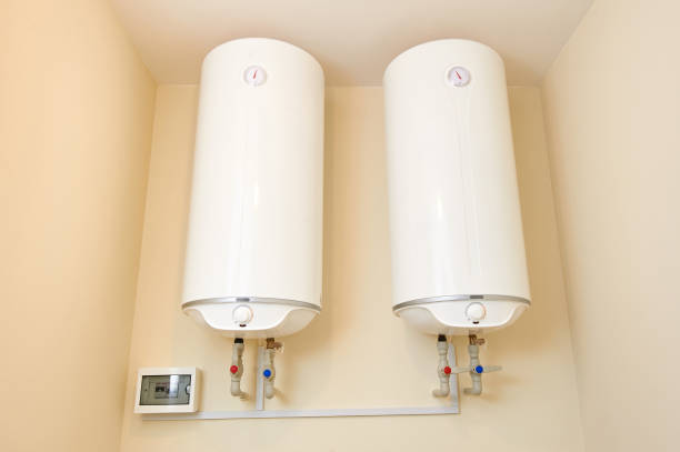 istock Two electric water heaters on the wall. Home wall mounted two water heating boilers. 1300523490