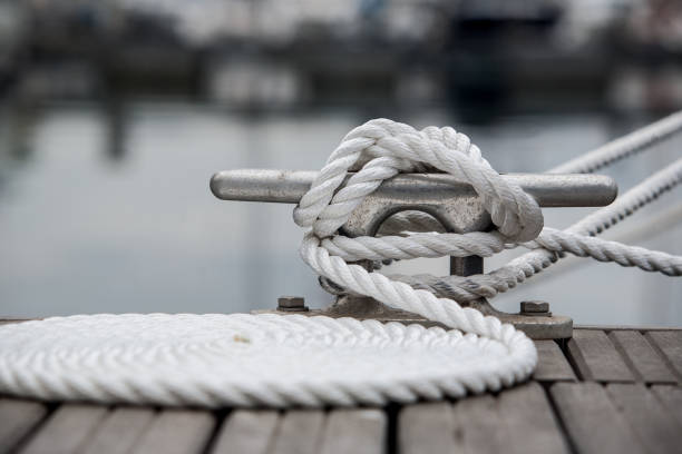 Mooring line Mooring rope on mooring cleat. Coiled mooring line. mooring line stock pictures, royalty-free photos & images