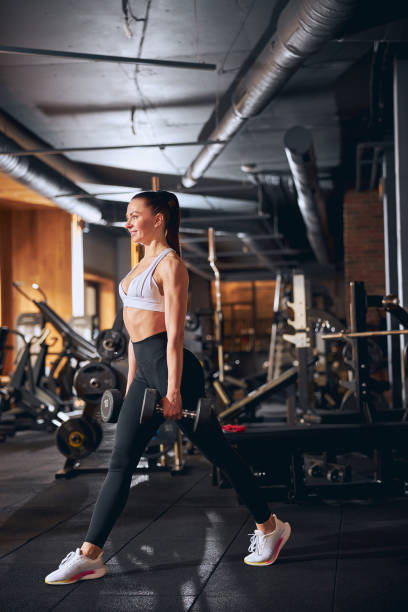 istock Merry young woman spending active time in gym 1300527247