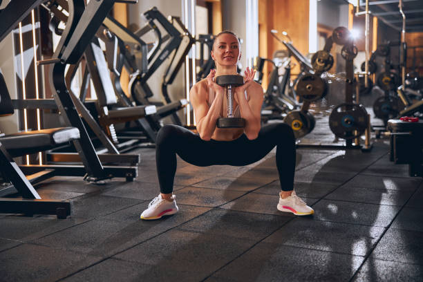 istock Smiling fit female during strength workout in gym 1300527248