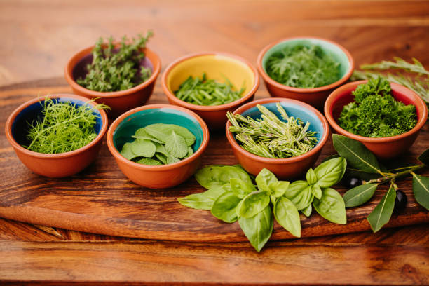 istock Seven herbs on a rustic wooden board in bowls 1300528812