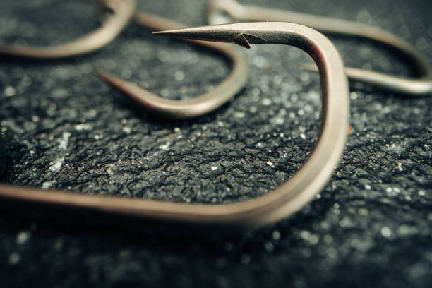 istock Macro photo of fishing hook on grey background 1300529944