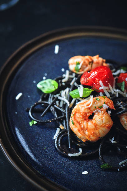 istock Spaghetti Nero Pasta with Shrimp Scampi and Cherry Tomato 1300529999