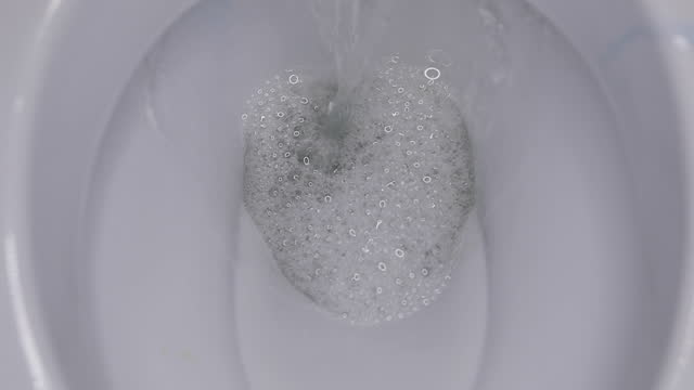 toilet flushing process, close-up, slow motion, plumbing and house cleaning concept