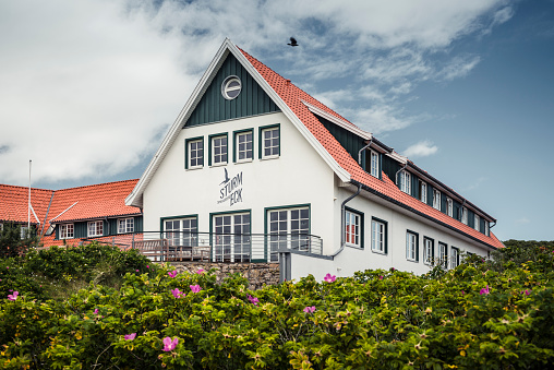 Spiekeroog, Germany - July 8, 2020: The Sturmeck Hotel. The traditional building stands on a dune in the west of Spiekeroog Island with a great view of the Wattenmeer National Park.