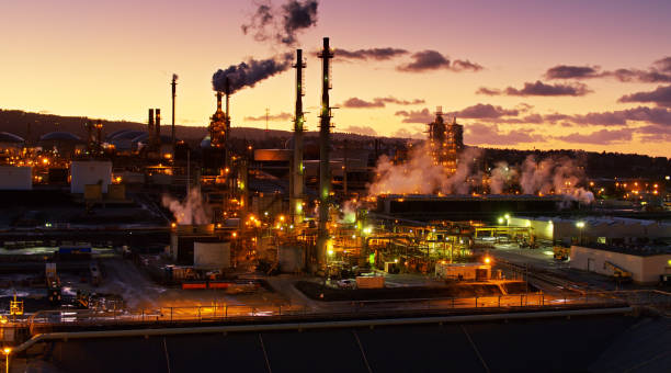 istock Aerial View of Refinery Under Sunset Clouds 1300534481