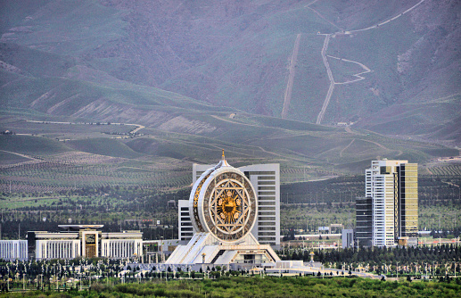 Ashgabat, Turkmenistan: skyline of the Archabil avenue government district - left to right: Ministry of Justice, Alem Center, Ministry of Economy and Finance and Ministry of Railway Transport, in the background the footpaths of the 'Sedar Health Walk', on the slopes of the Kopet Dag mountains (also known as the Turkmen-Khorasan Mountain Range, mark the border with Iran).