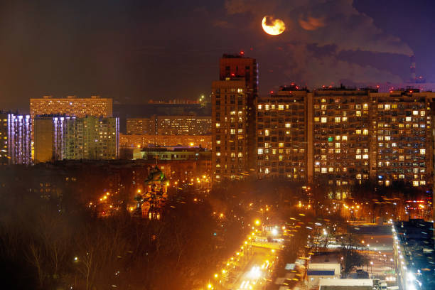 Cloudy sky and moon in the night. Moonlight over city. Moscow, Russia.