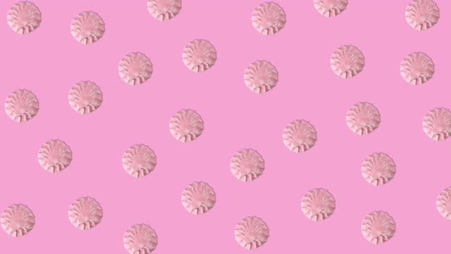 seamless looping animation of many pink marshmallows that wiggle on a pink background, copy space