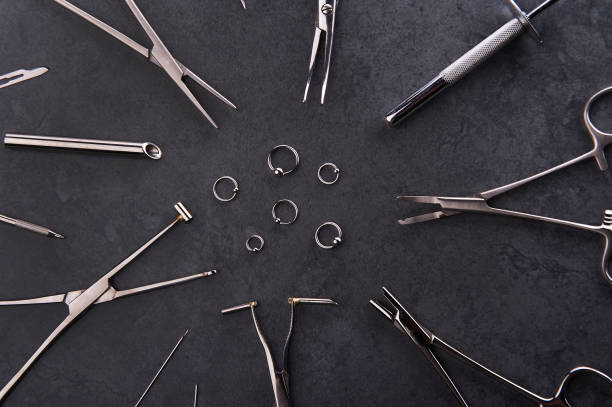 Piercing earrings, stainless steel clips for disinfection on a black background