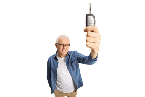 Mature man showing a car key in front of camera