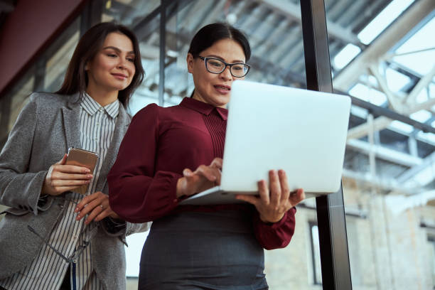 istock Two cute females staring at screen of computer 1300537021