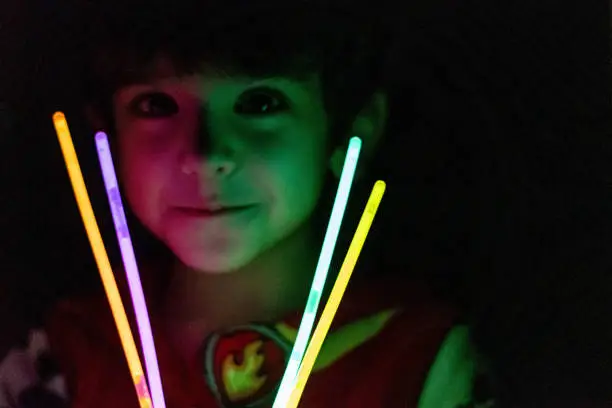 Photo of A boy playing with glow stick