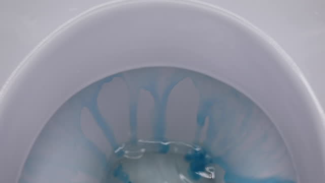 the process of washing the toilet with an antibacterial cleaner, close-up, slow motion